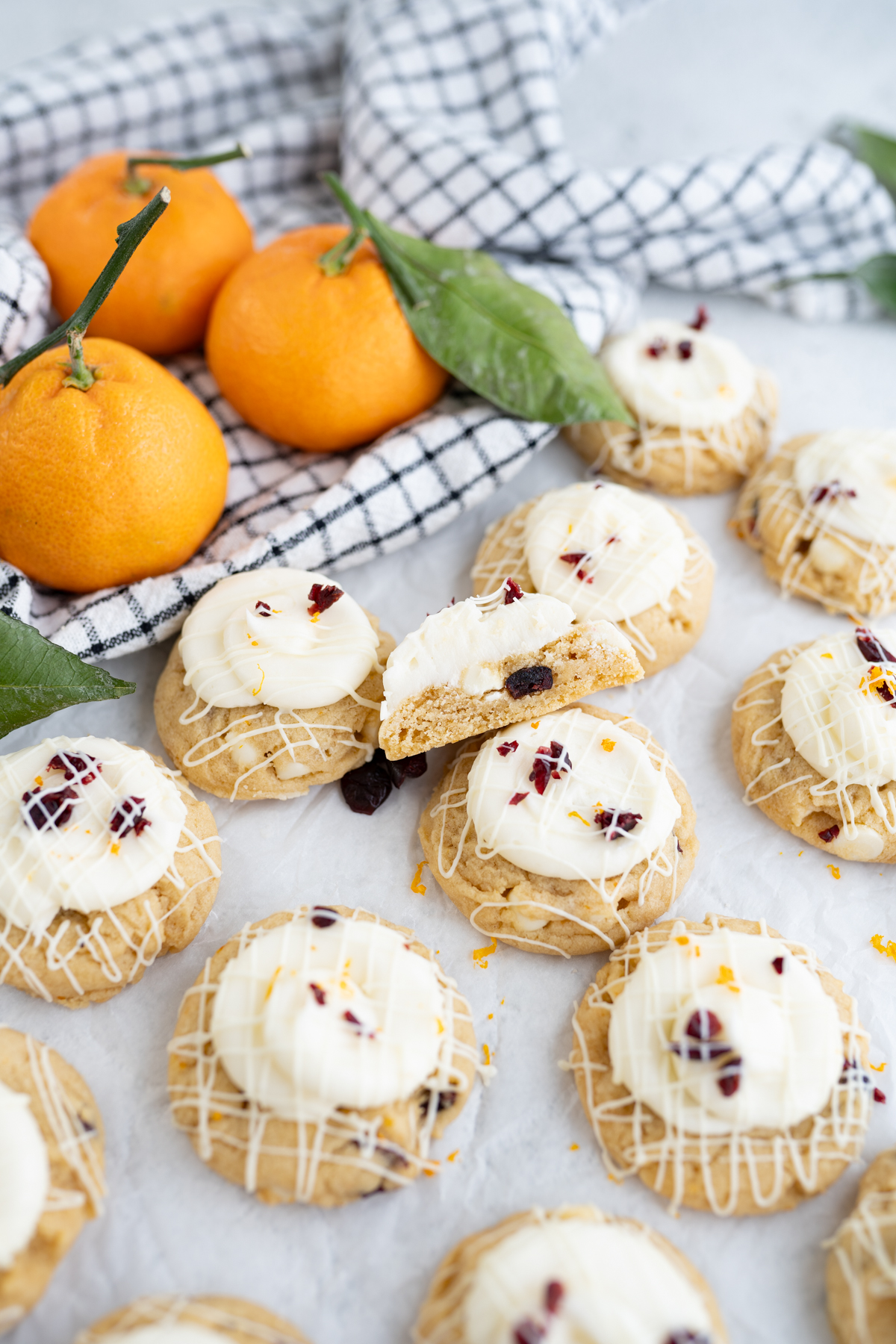 Starbucks style mini cranberry bliss cookies next to oranges. 