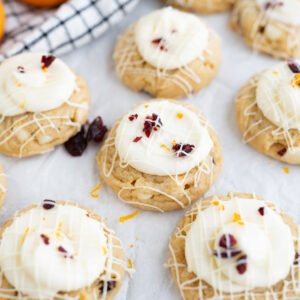 Mini cranberry, orange white chocolate cookies frosted with cream cheese frosting to mimi starbucks bliss bars.
