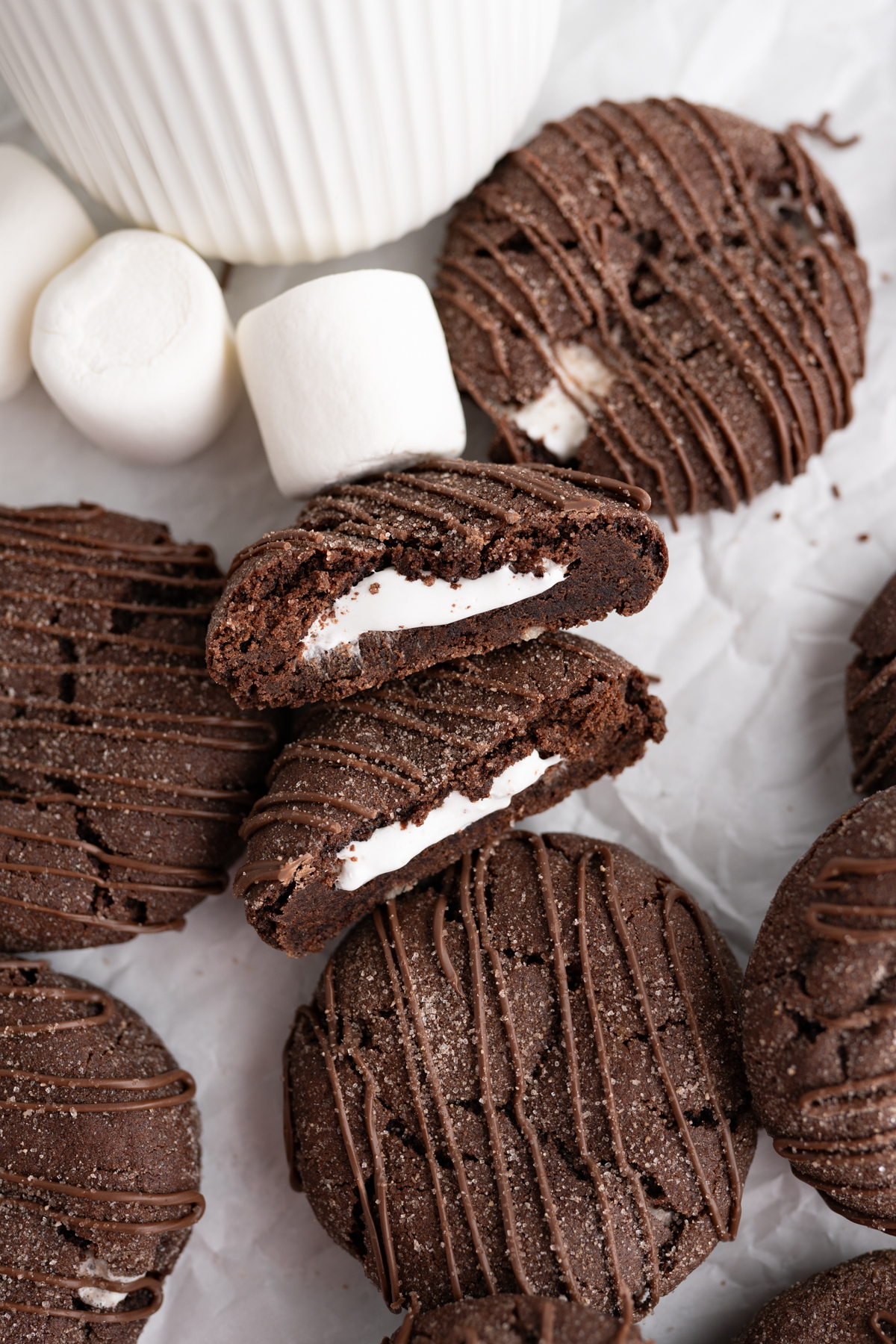 A hot cocoa bomb cookie cut in half to show the interior marshmallow. 