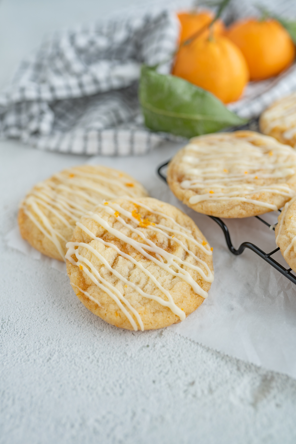 Close up of a sugar cookie with orange roll filling and glaze. 