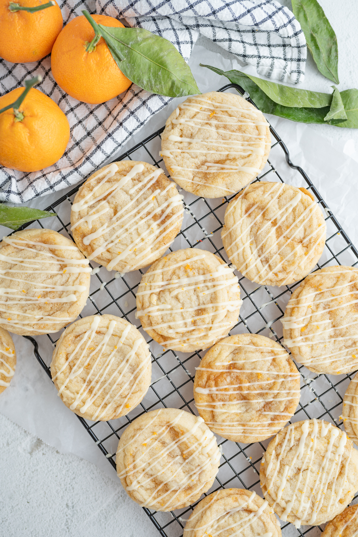 Aerial view of sweet orange roll cookies on a cooling rack. 