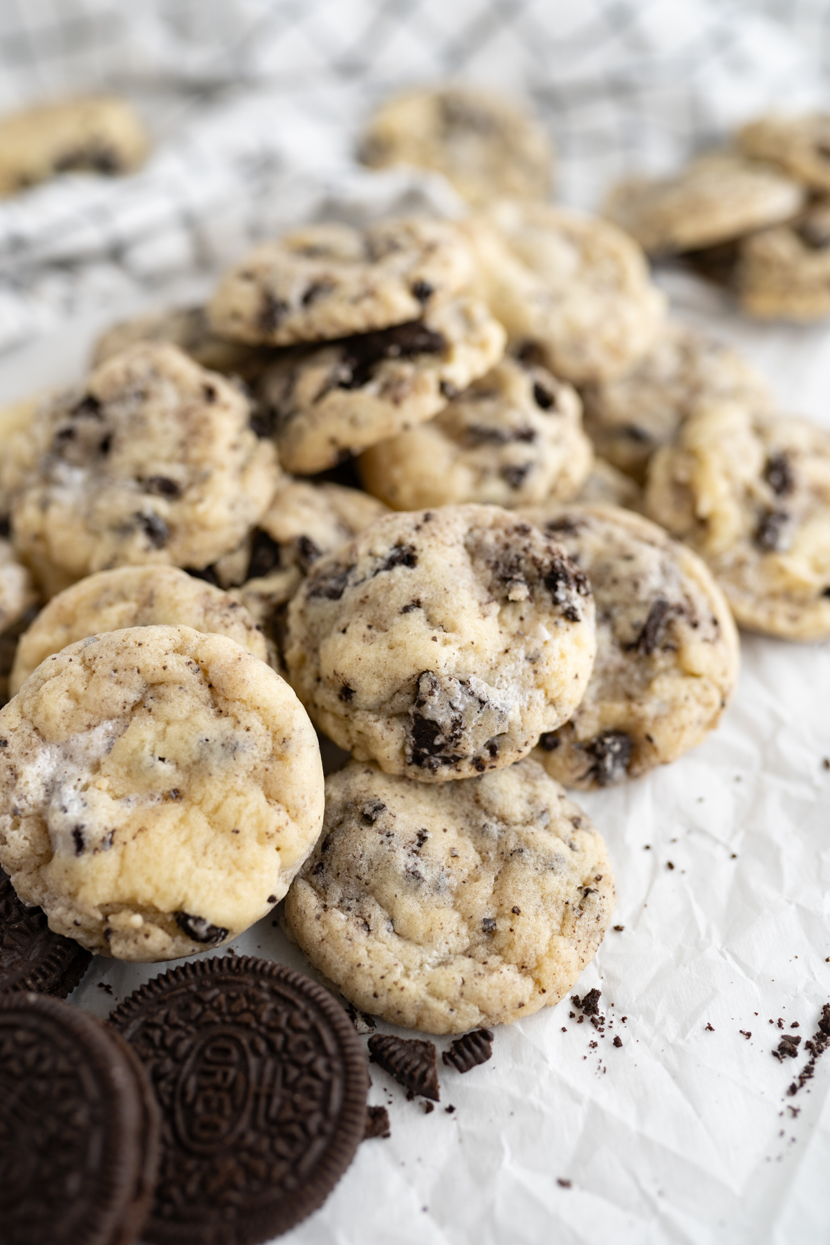 Side view of a pile of oreo, marshmallow cake batter sugar cookies. 