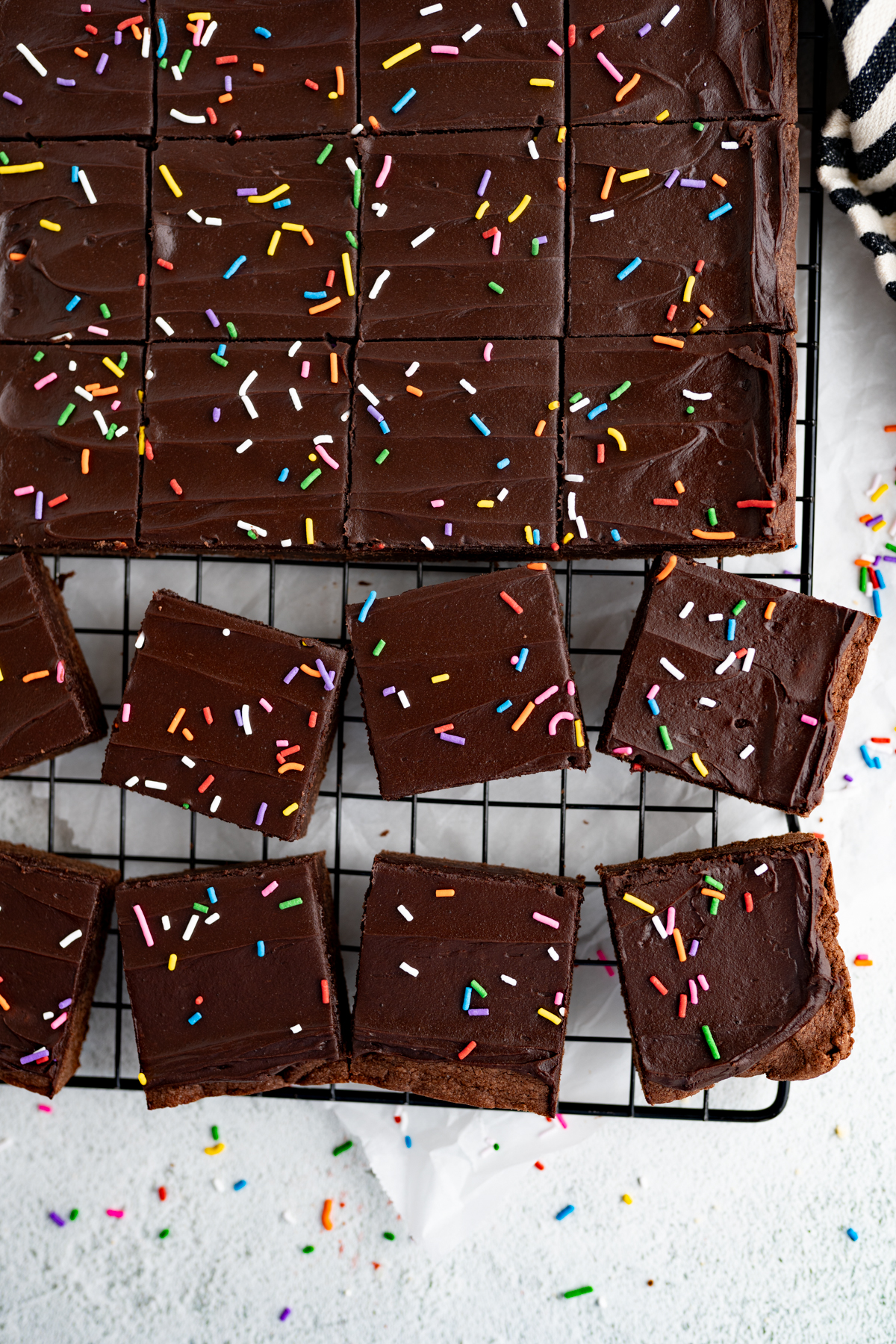 Aerial view of chocolate sugar cookie bars arranged on a cooling rack. 
