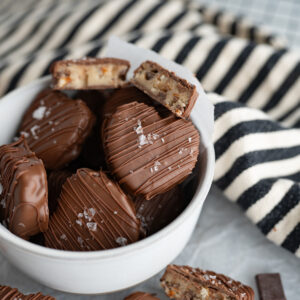 A bowl of heart shaped chocolate covered cookie dough.