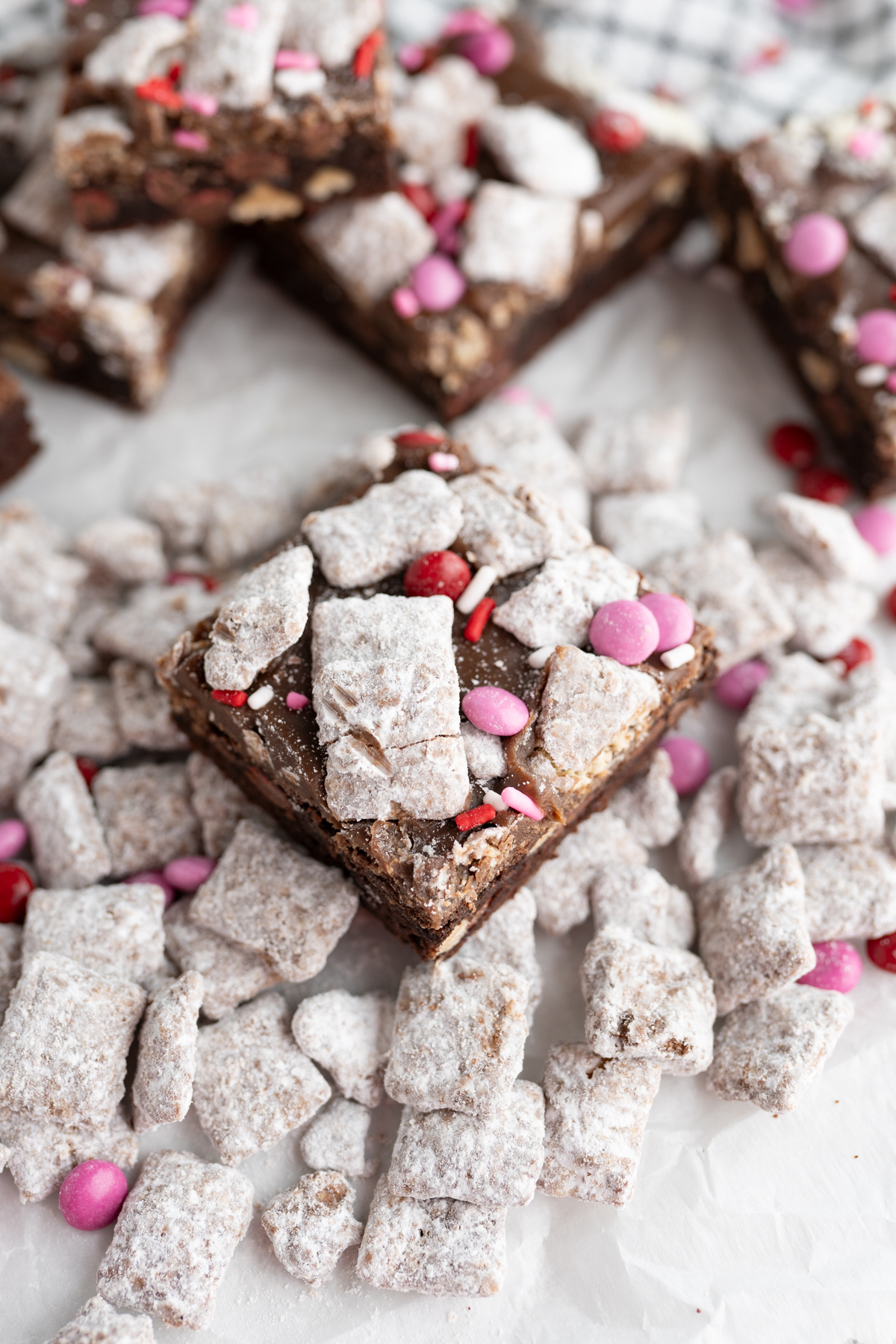 A puppy love Valentines cookie bar sitting on top of muddy buddies. 