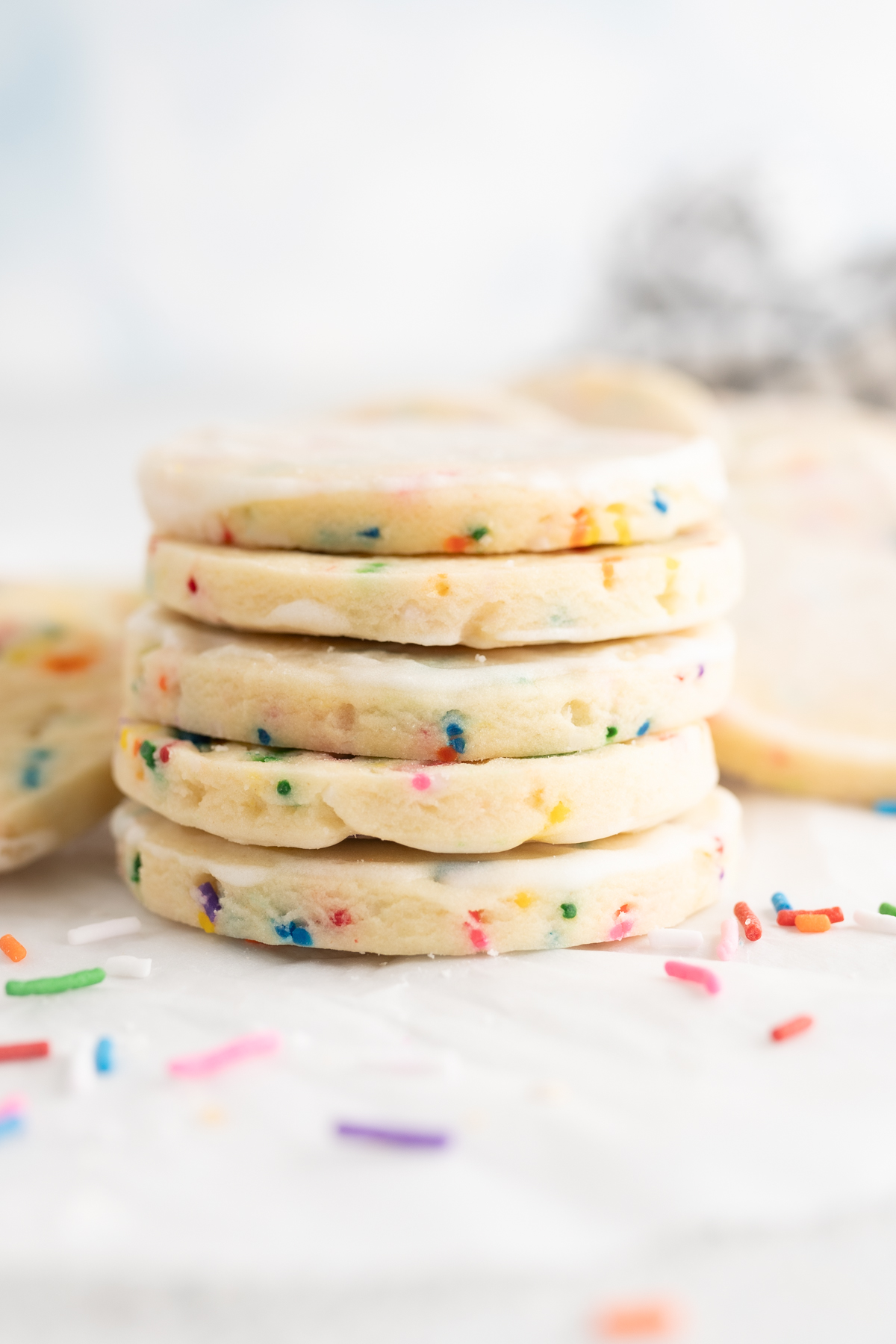 Side view of a stack of cake batter cut out cookies. 
