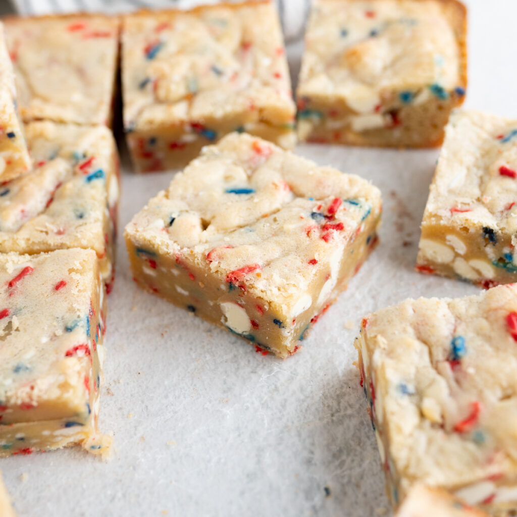 A cake batter blondie with red, white, and blue sprinkles.