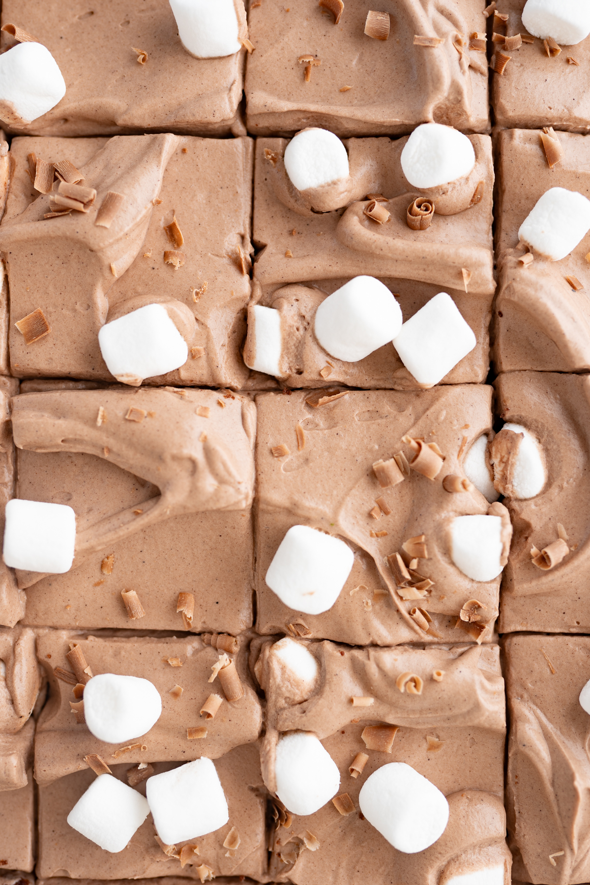 Aerial view of a pan of hot cocoa bars cut into squares. 