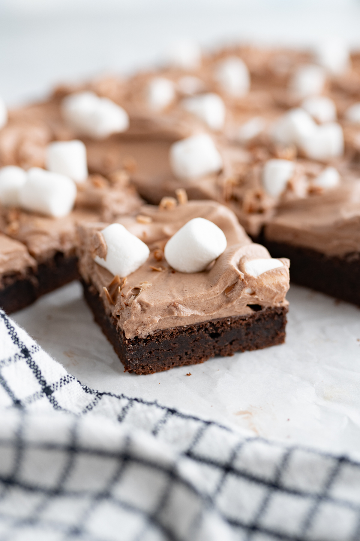 Side view of a frozen hot cocoa cookie bar. 