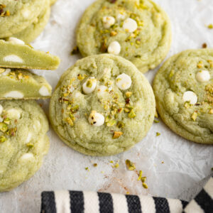 A soft pistachio cookies with white chocolate chips.