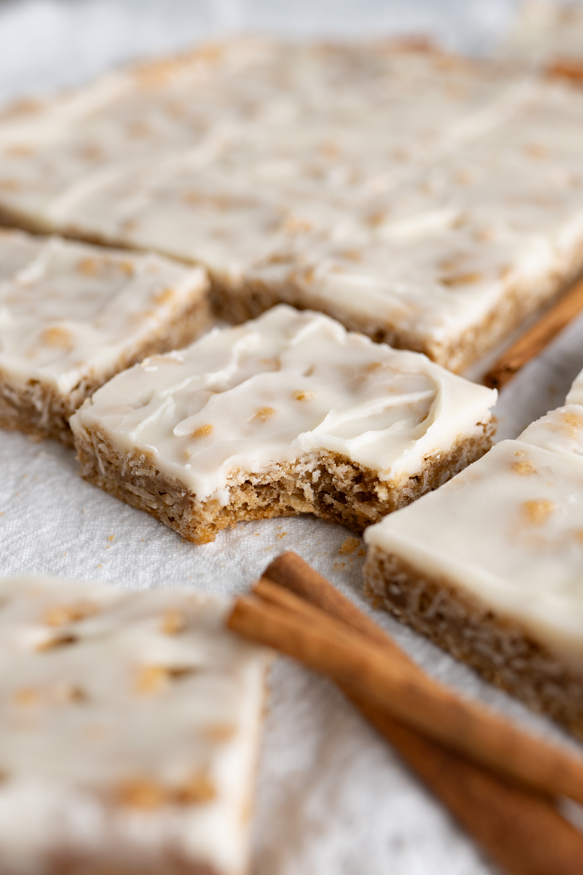 An oatmeal cookie bar with a bite taken out of it. 
