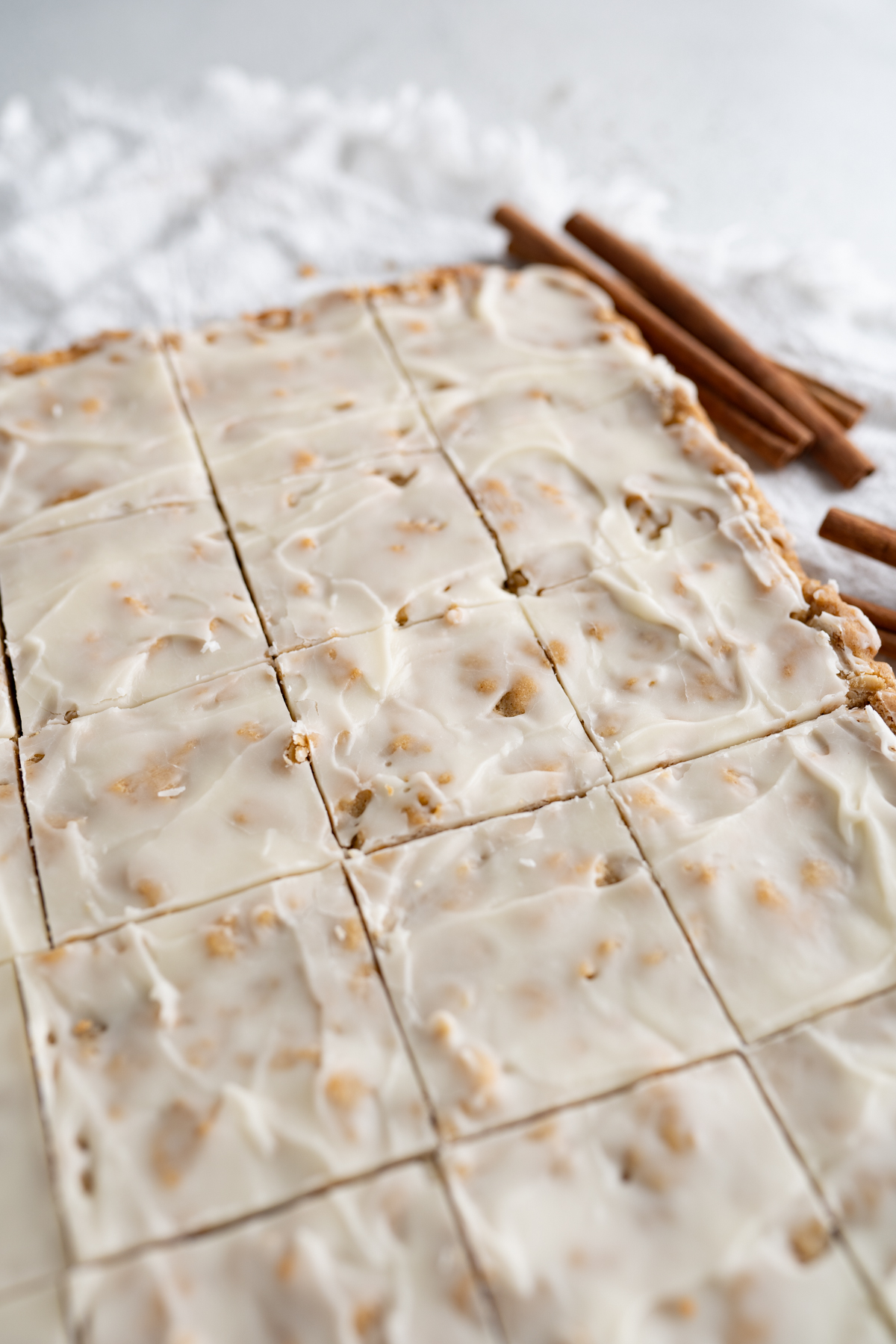 Aerial view of a pan of iced oatmeal cookie bars. 