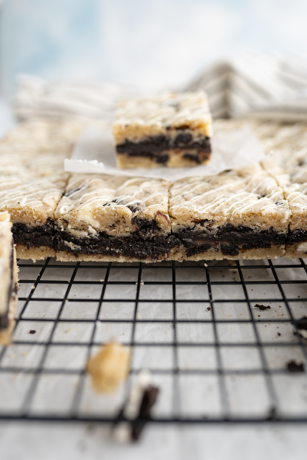 Side view of a cookies n cream cookie bar filled with oreo truffle. 