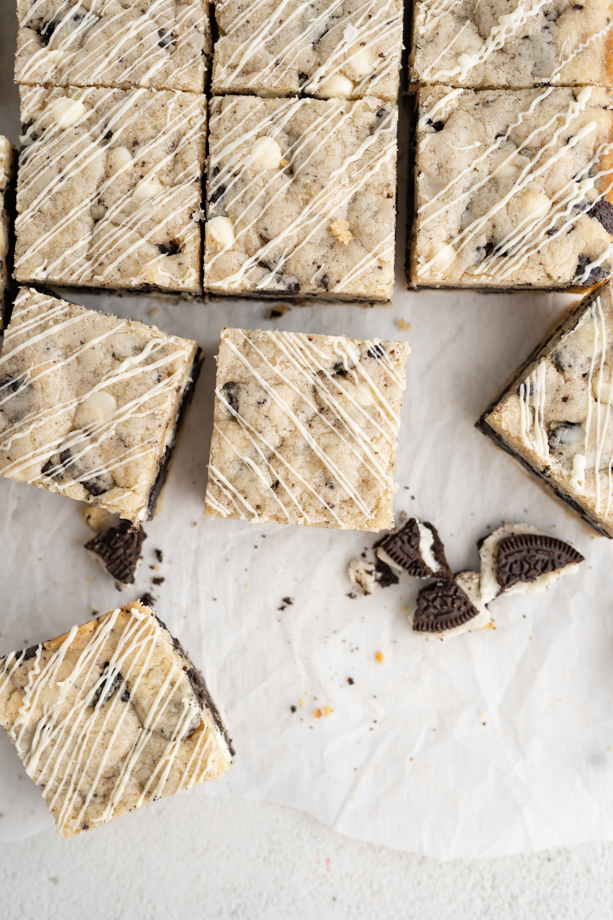 Aerial view of oreo cookie bars filled with oreo truffle, cookie pieces, and white chocolate chips. 