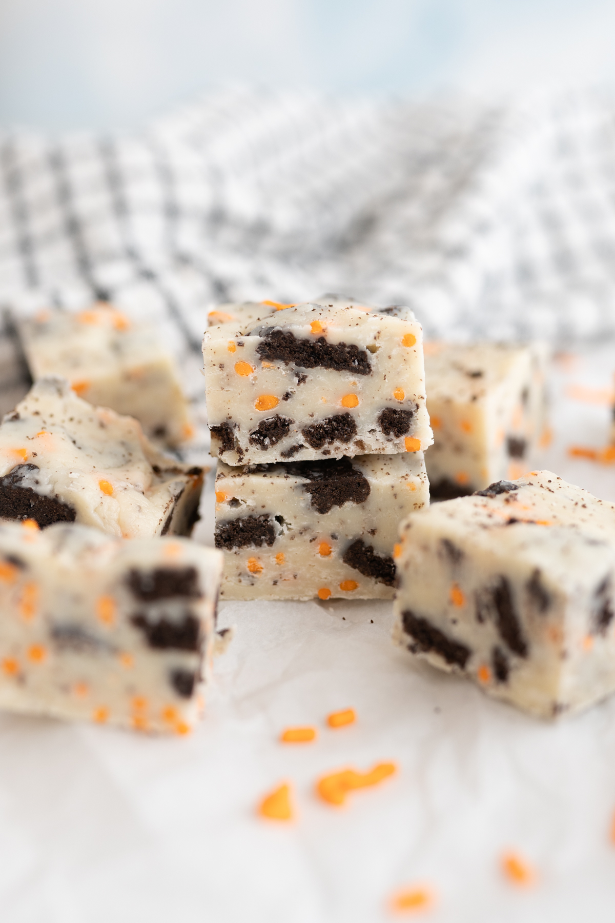 Side view of a cookies and cream fudge with orange sprinkles for halloween. 