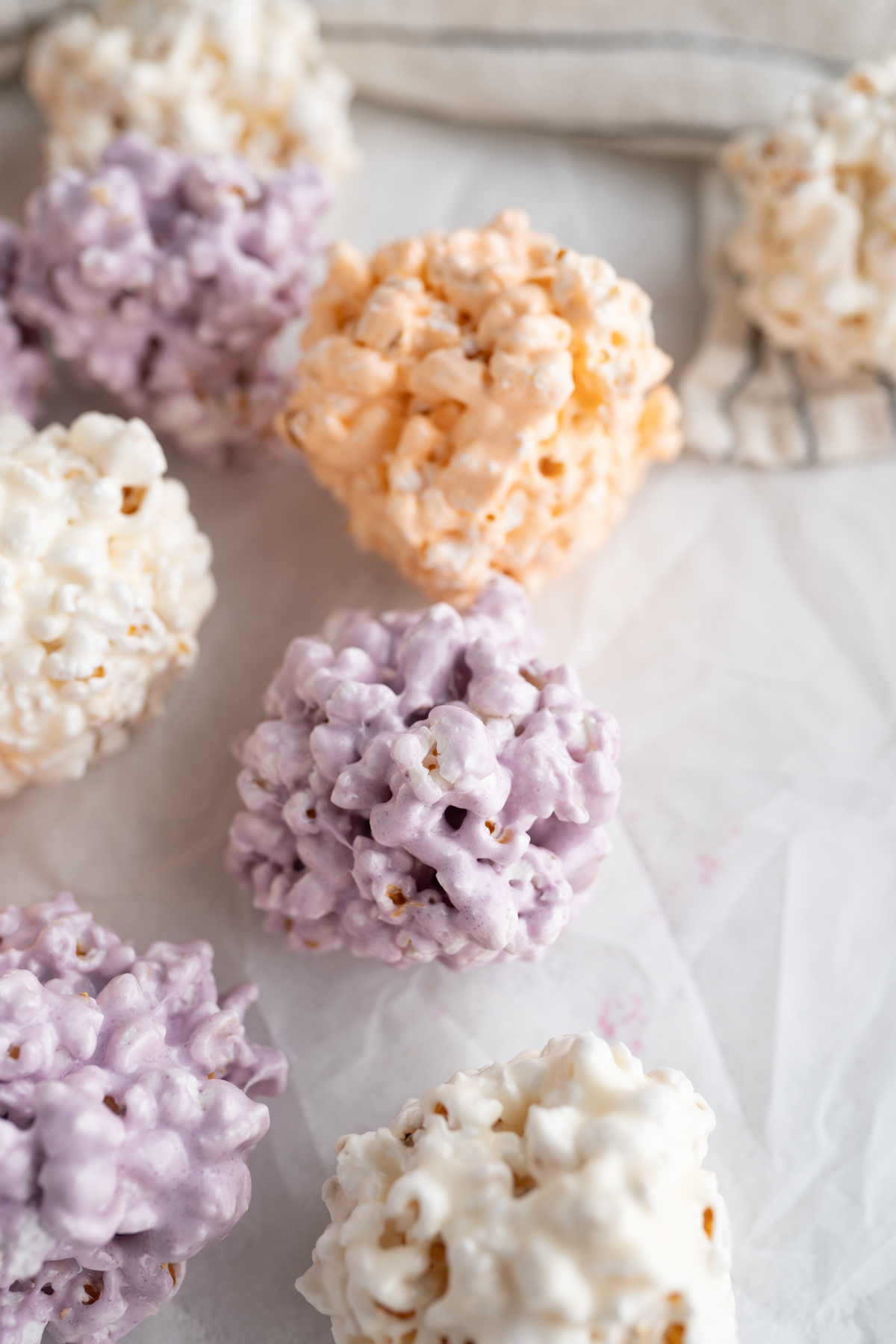 Aerial view of halloween popcorn balls colored purple, orange, and white. 